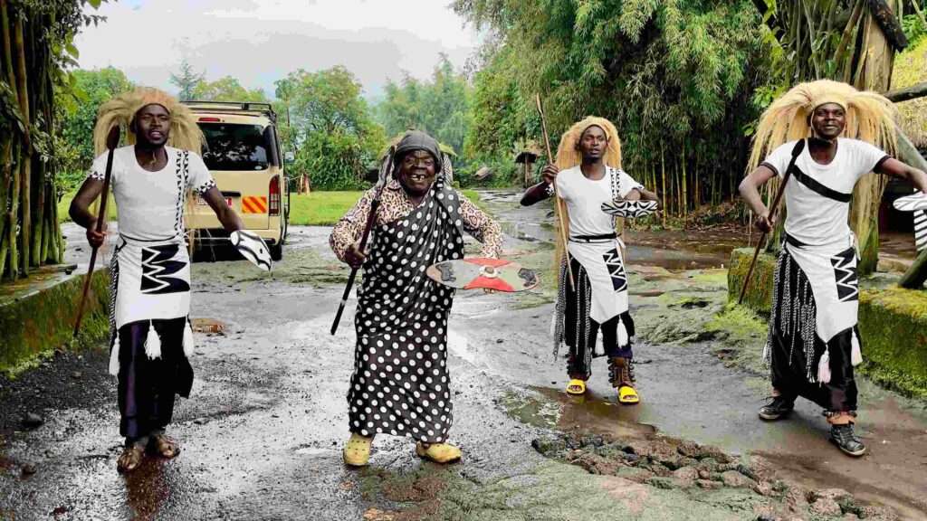 The Four Rwandan men welcome the visitors in the gorilla-guardian-village