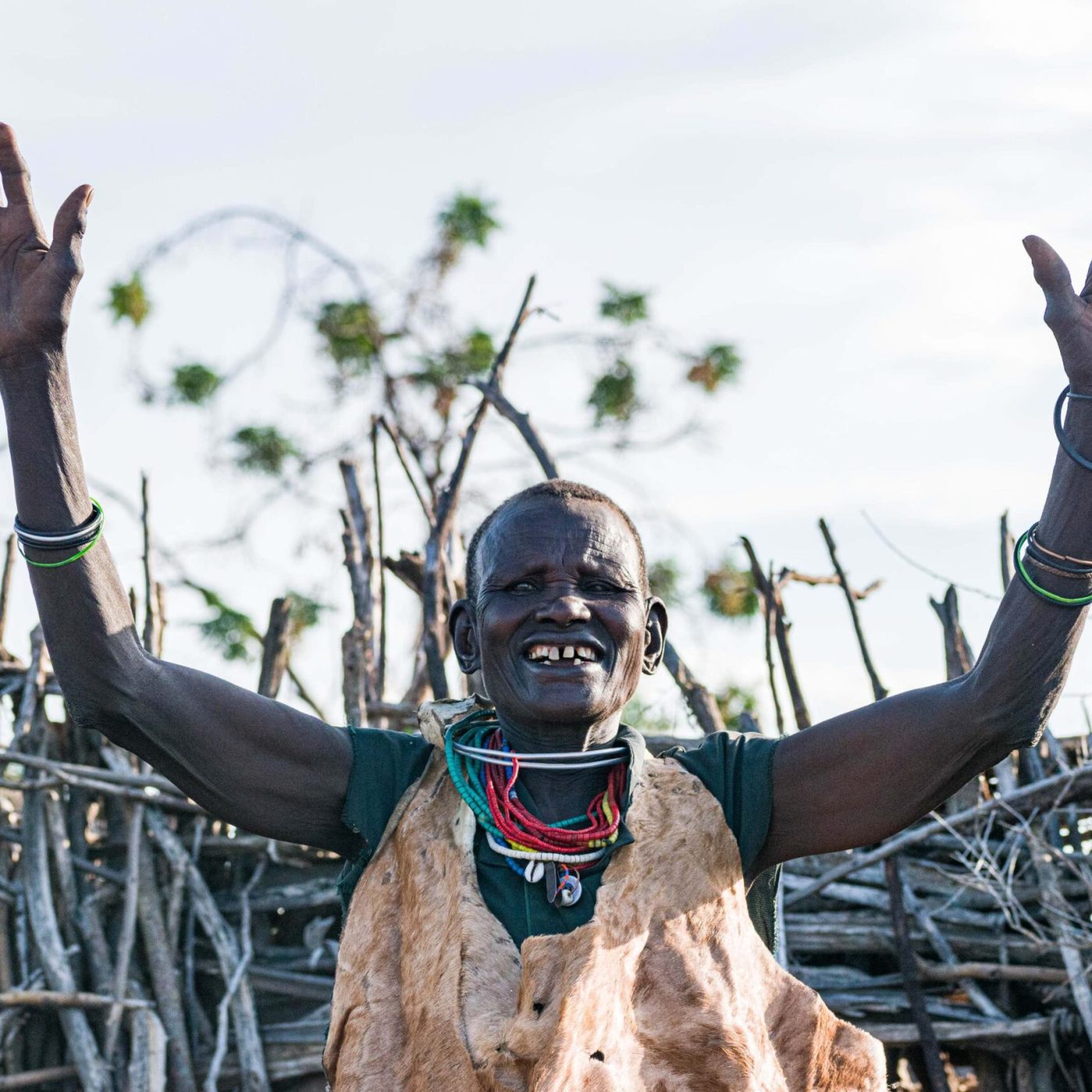 The Karimojong lady welcomes us to the community well dressed in her traditional attire